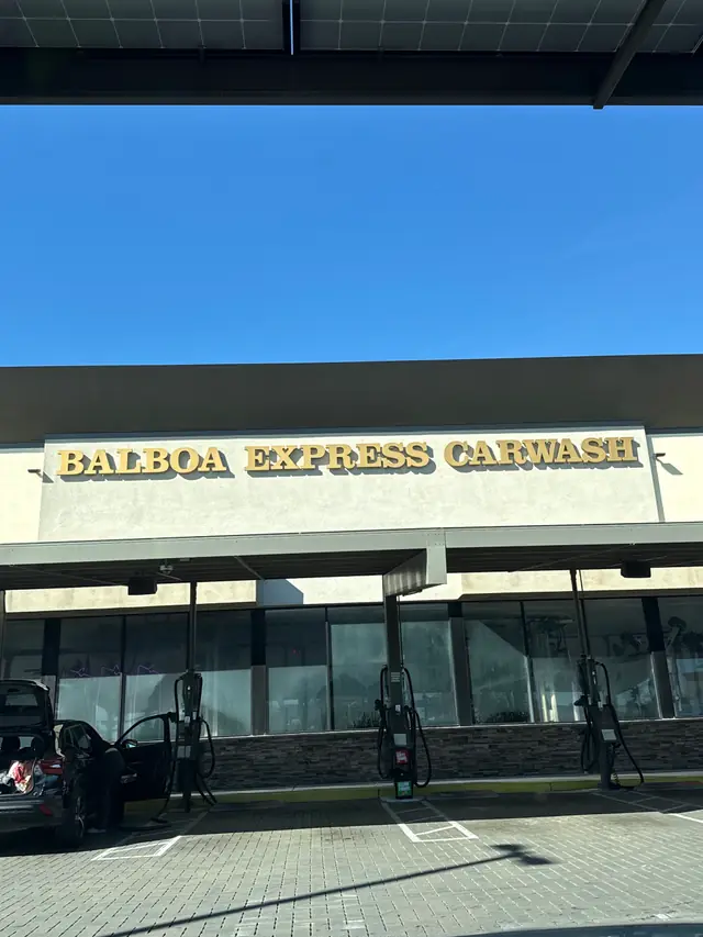 The gold BALBOA EXPRESS CARWASH letters over the shopfront and vacuum posts